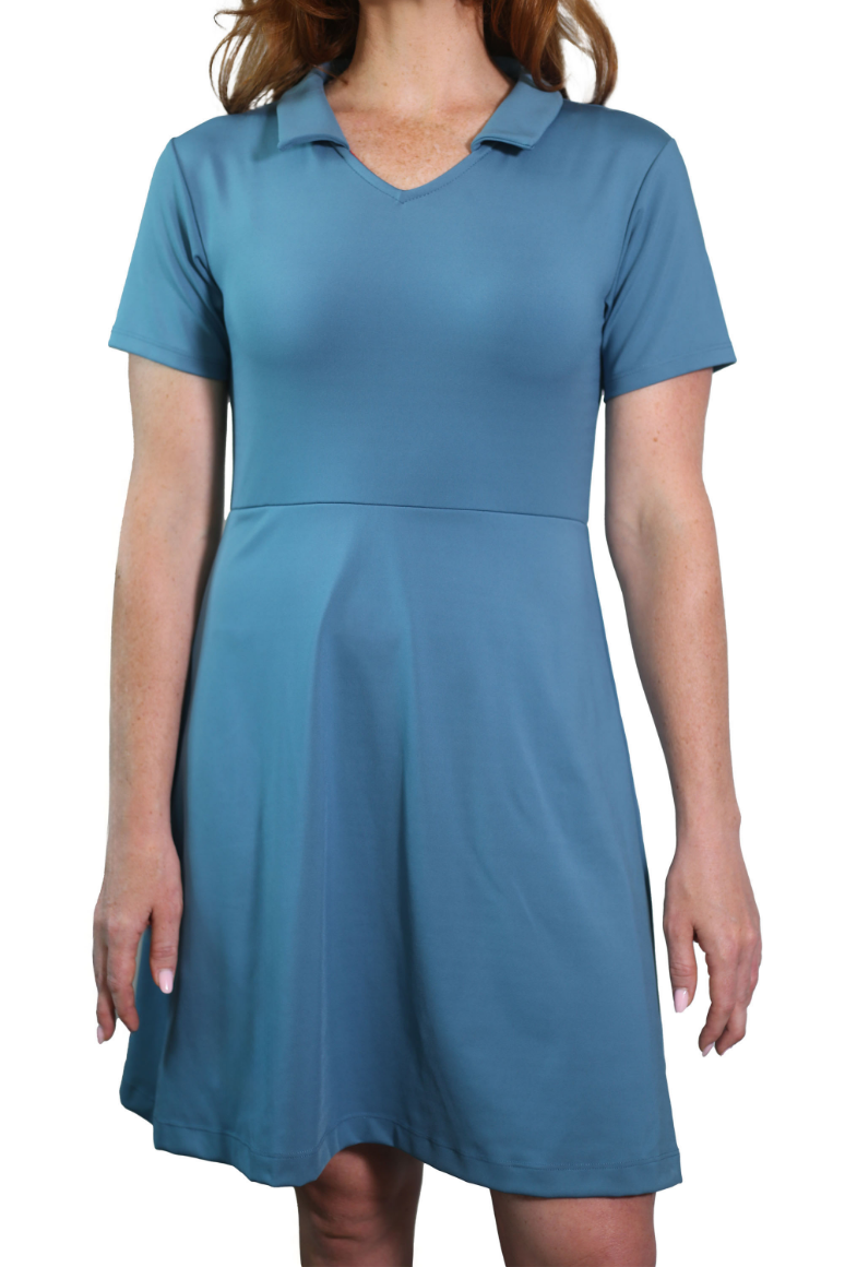 Woman wearing Clarece Polo dress in light blue featuring made from recycled performance fabrics and offering 4-way stretch, UV protection, and moisture-wicking for versatility, comfort and flexibility.