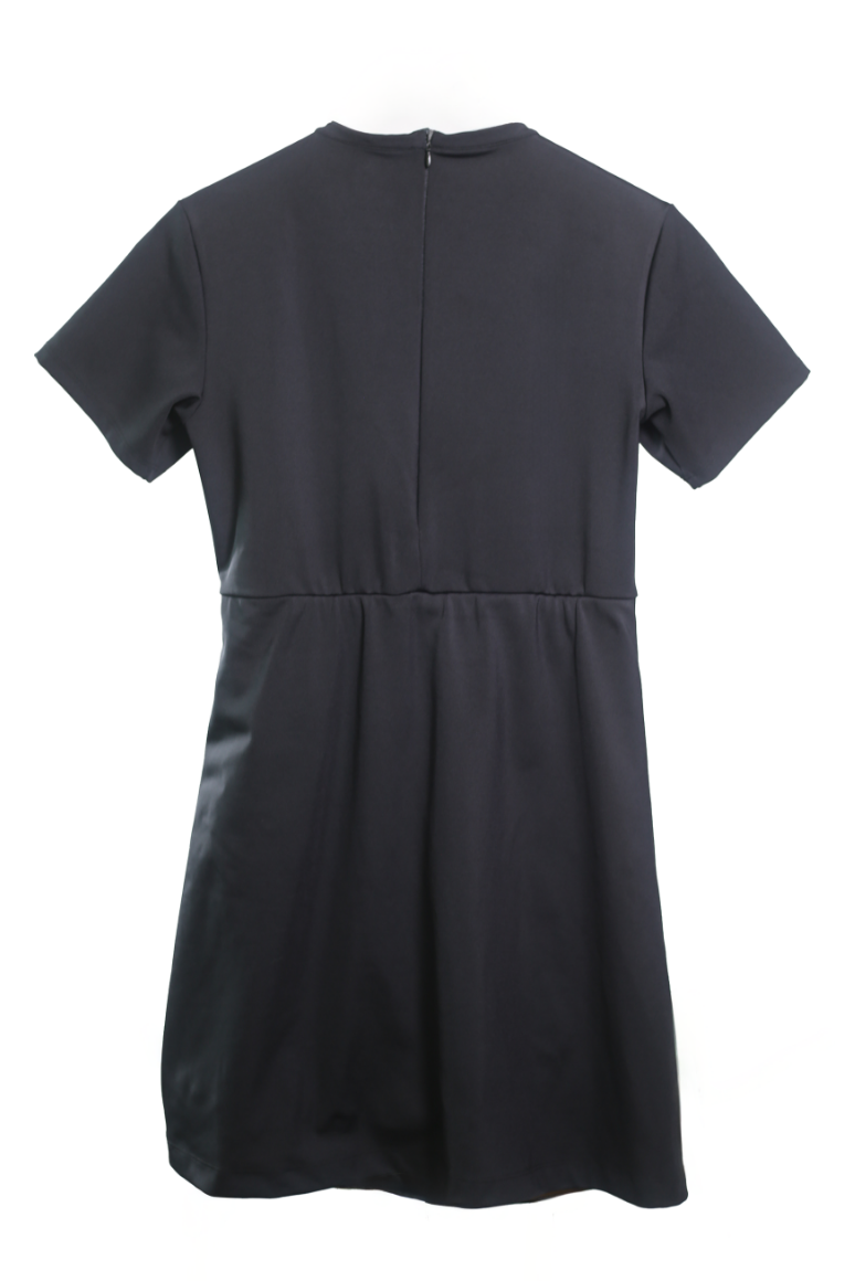 The Ace Henley Dress in black showcasing the back full-body silhouette, cinched waistline, and zipper from waist to collar.